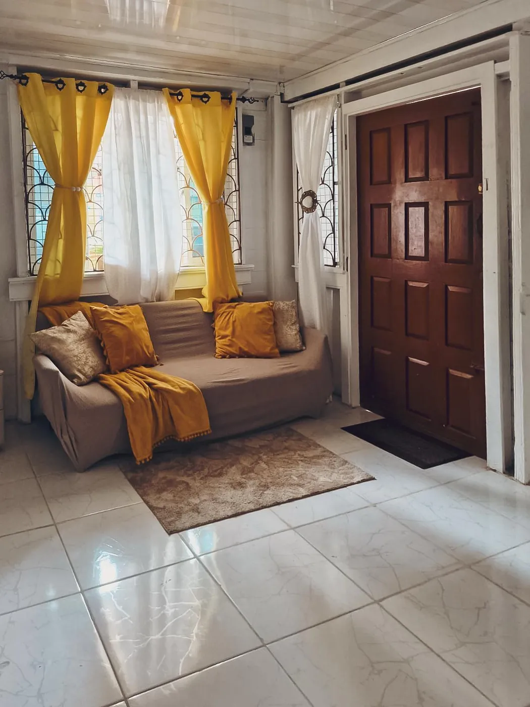 Queenstown Haven living room with golden curtains and sofa